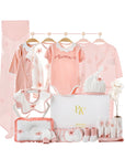 Close-up of newborn essentials with pink and floral designs, perfect for summer baby gifting