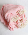 Pink cotton baby blanket with tassels for newborn comfort