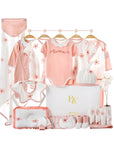 Pink summer floral baby gift set with wrap, bodysuit, socks, bibs, towel, and pillow in a gift box