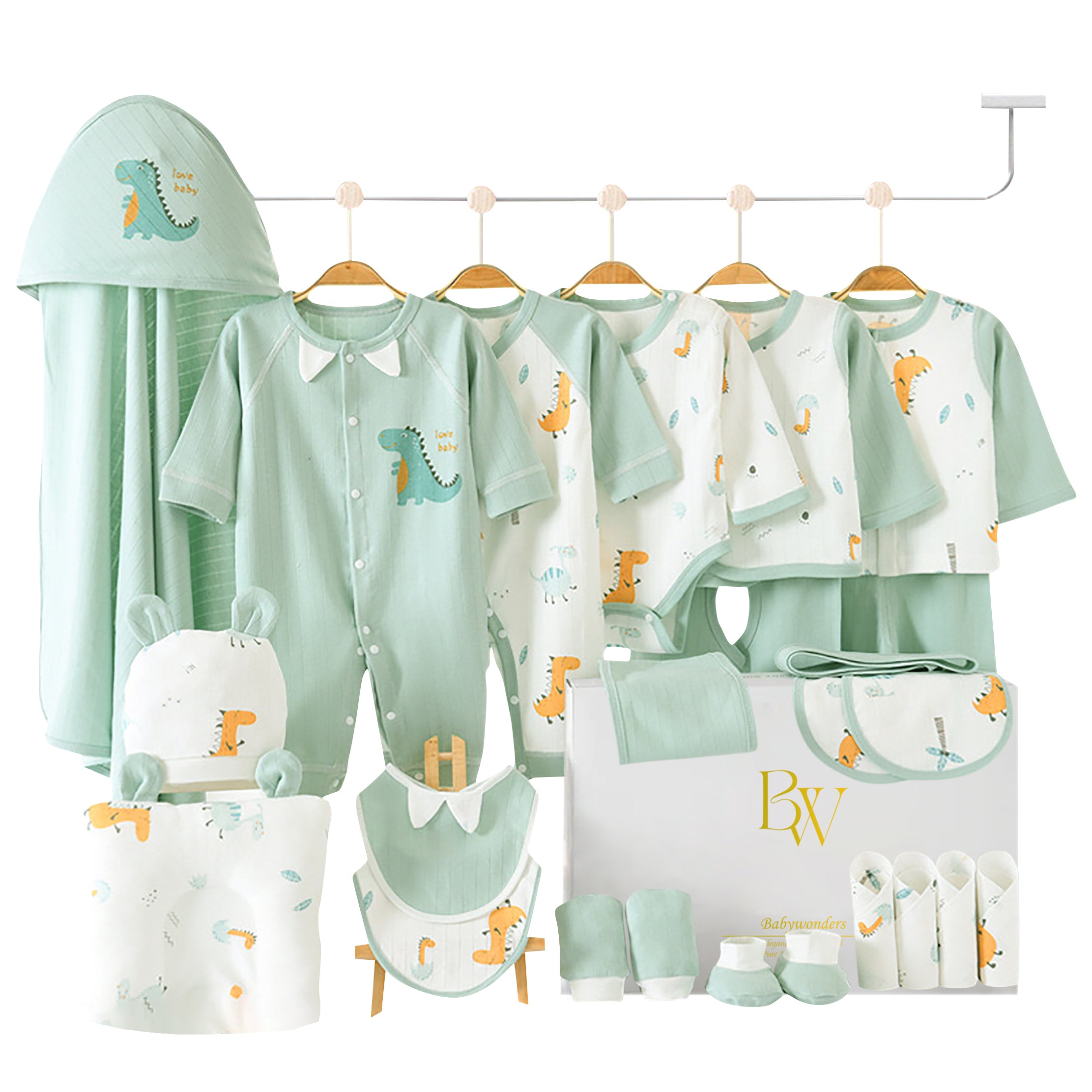 Green dinosaur baby gift set with bodysuit, bibs, socks, gloves, towel, pillow, and wrap arranged in a gift box