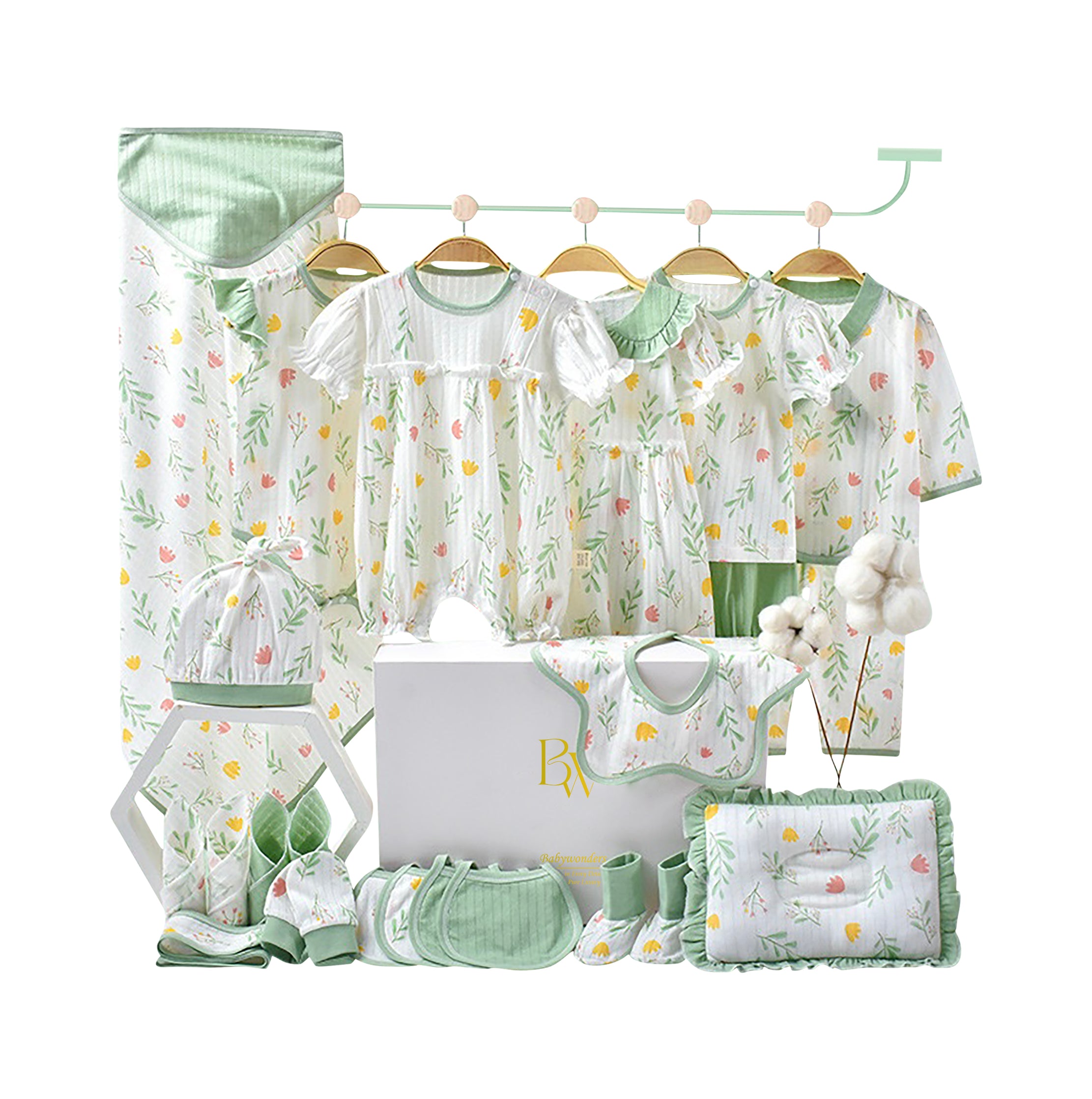 Glitter floral baby gift set with wrap, bodysuit, bibs, mittens, towel, pillow, and socks in soft pink and green tones