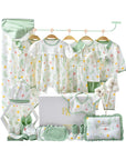 Glitter floral baby gift set with wrap, bodysuit, bibs, mittens, towel, pillow, and socks in soft pink and green tones