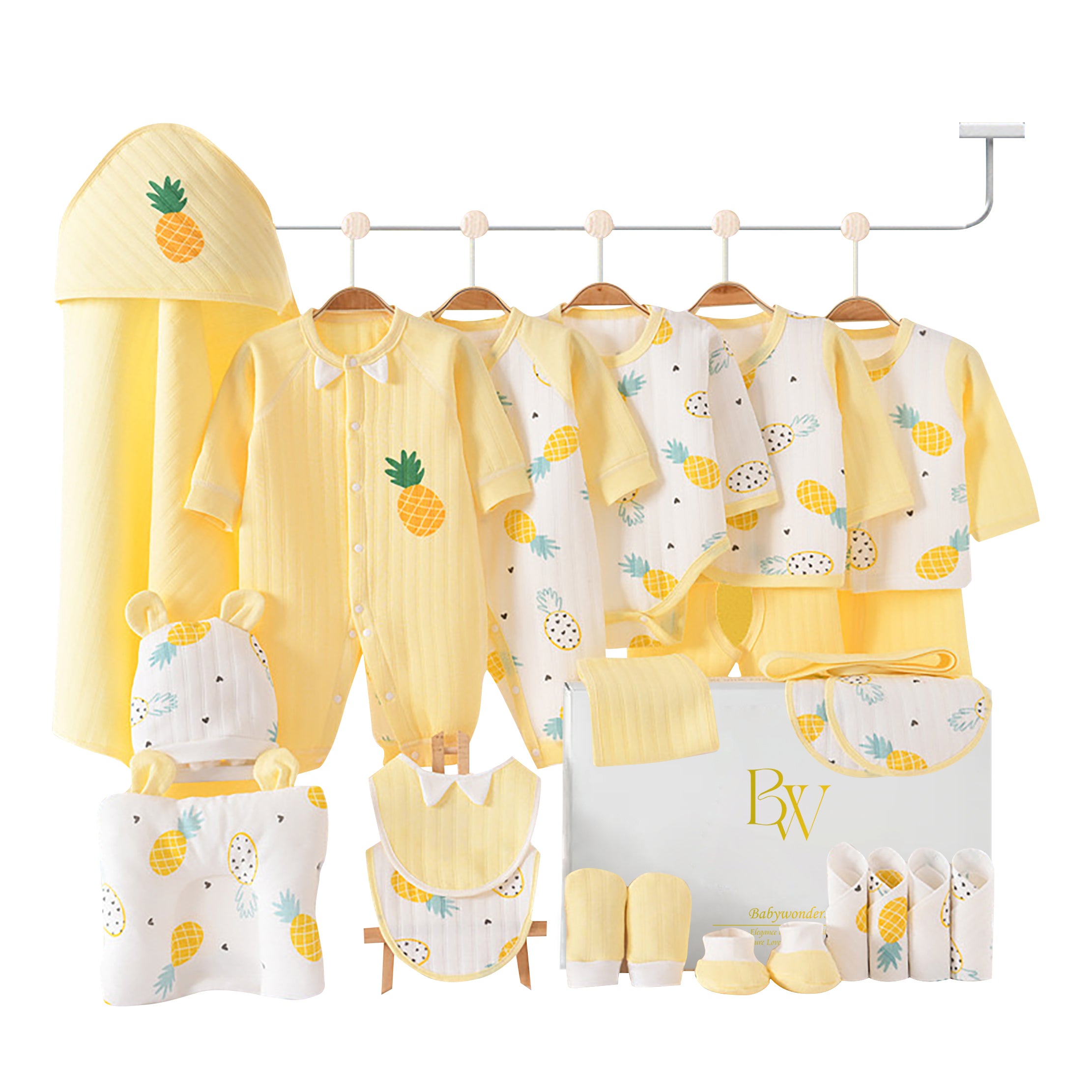 Close-up of newborn essentials with pineapple print and yellow accents, ideal for baby shower gifting