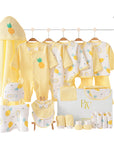 Pineapple-themed baby gift set with bodysuit, bibs, towel, wrap, socks, gloves, and pillow in a tropical-inspired gift box