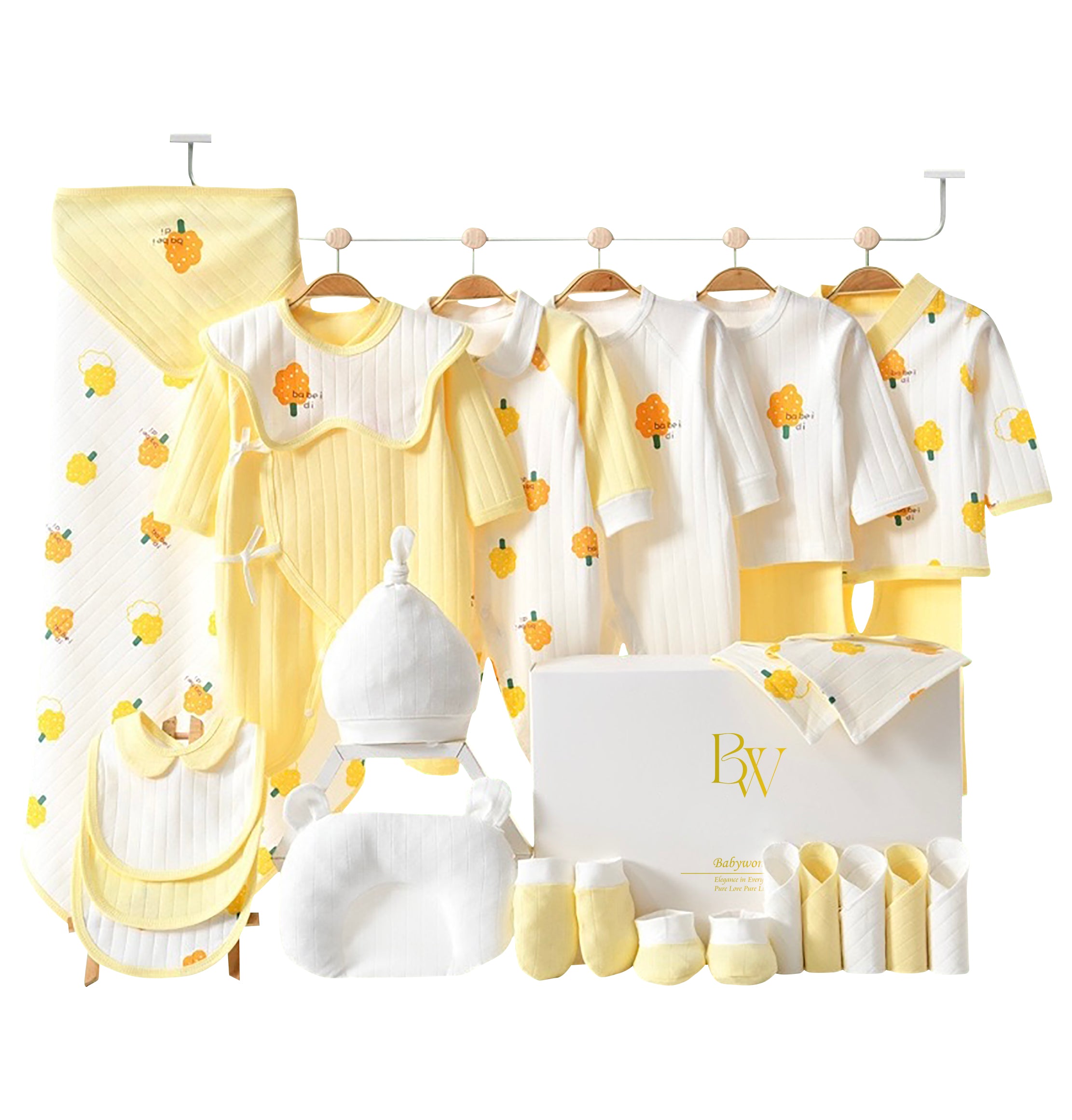 Nature-themed baby gift set featuring yellow tree print bodysuit, mittens, and socks in neutral tones