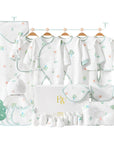 Tree-themed baby gift set with bodysuit, bibs, wrap, socks, gloves, towel, and pillow in soft earthy tones