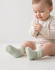 Baby wearing soft thick winter socks in pastel tones, warm and cozy cotton blend