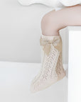 Beige baby lace knee-high socks with grosgrain bow, soft cotton knit for toddlers