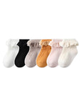 Set of six baby socks with lace frill trim in assorted colors, soft cotton and non-slip design.