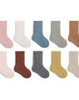 Ten pairs of baby ribbed cotton socks in pastel and earthy tones arranged neatly on white background