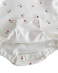 Close-up of baby romper set snap button bottom with soft cotton lining and floral print, easy nappy change design from 4-pack baby outfit