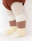 Baby wearing retro brown and cream striped ribbed socks – cozy winter outfit