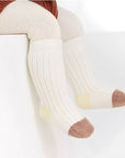 Baby wearing yellow and cream striped ribbed cotton socks – winter warm set