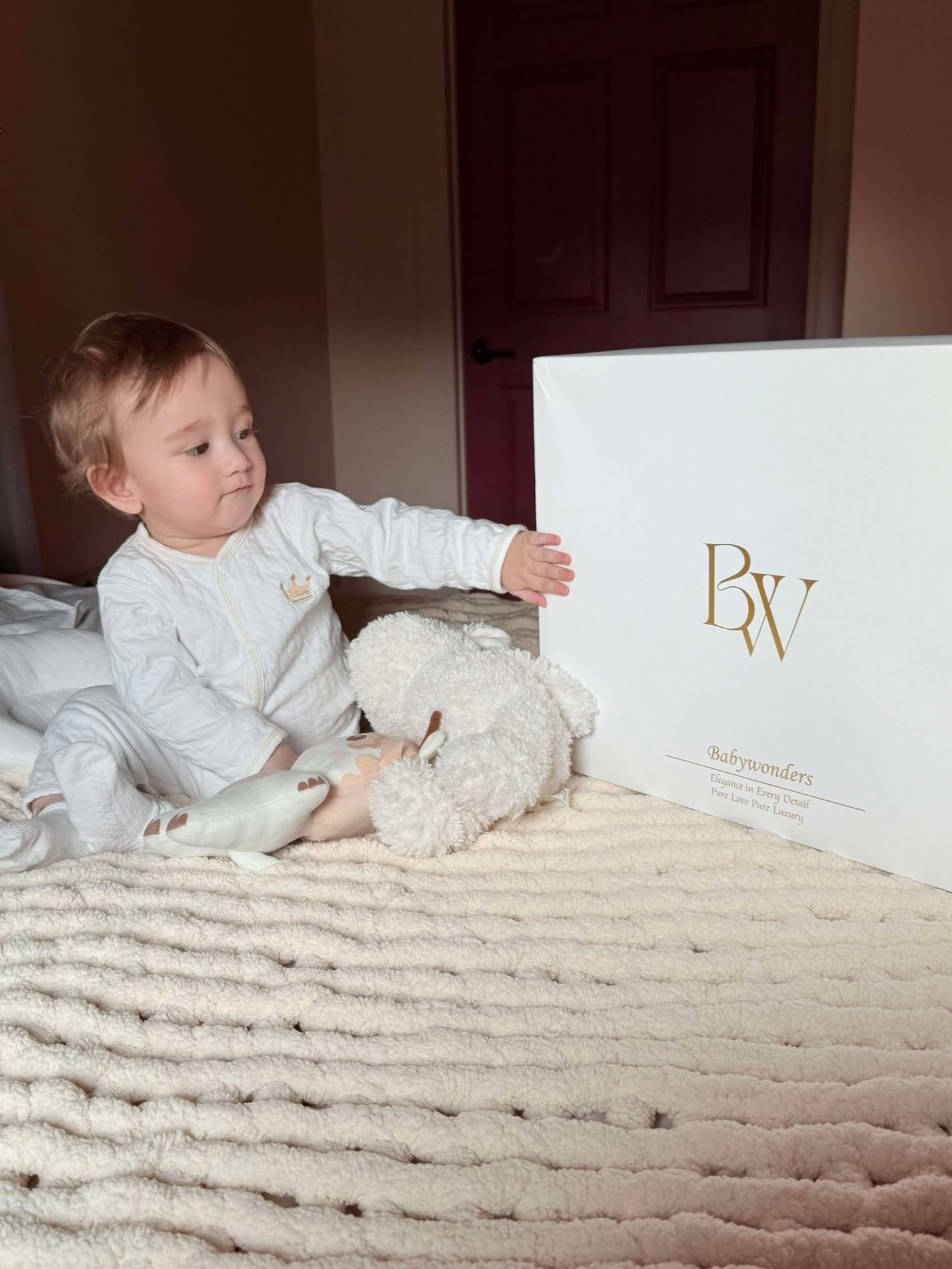 Happy baby with Babywonders gift box, trusted by over 1 million families in the UK