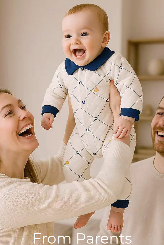Happy parents lifting their baby dressed in Babywonders outfit