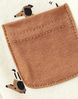 Brown pocket detail with cute puppy print on beige cotton baby romper.