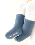 Baby wearing blue cotton anti-slip socks for warmth and comfort