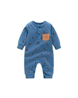 Front view of blue cotton baby romper with puppy print and brown chest pocket.