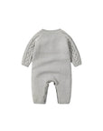 Baby cable knit romper back view with ribbed trim and soft knitted finish