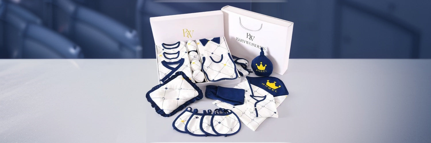 Luxury BabyWonders newborn baby boy gift set in blue and white, including babywear, bibs, hat, mittens, and soft accessories, beautifully packaged for baby showers and newborn gifting.