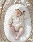 Baby wearing classic ribbed long baby socks in soft cotton knee-high style with cosy neutral nursery outfit and natural sunlight setting