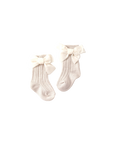 Cream baby socks with soft velvet bows — elegant ribbed cotton socks for baby girls.