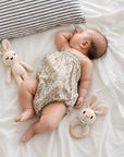 Newborn baby resting beside a crochet bunny comforter and bunny rattle set, a thoughtful baby shower gift and newborn essential in the UK.