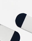 White baby socks with embroidered bear detail and navy cuff