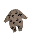 Back view of brown baby knit cherry romper featuring cute black cherry pattern.