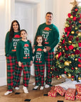 Family matching Christmas elf pajamas set with green tops and red plaid pants, holiday photo by Christmas tree