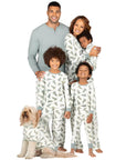 Family in matching Christmas pajamas with tree print