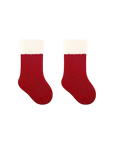 Pair of red baby socks with soft white fluffy cuffs, cozy Christmas Santa-style design.