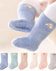 Baby wearing blue fluffy bear embroidered winter socks – soft and warm cotton design