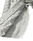 Close-up of sleeve and leg ribbed cuffs on gray cable knit baby romper, showing premium soft knit quality.