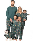 Parents and children in matching green animal print Christmas pajamas for family photos
