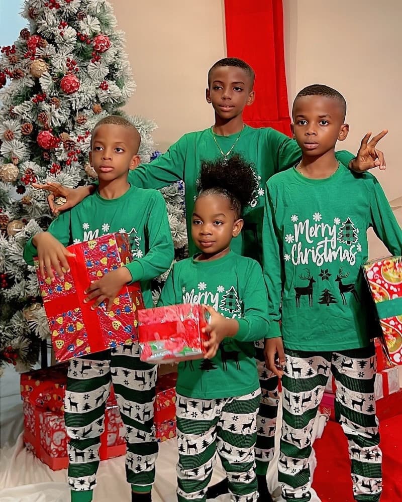 Children wearing matching green Merry Christmas pajamas with festive reindeer design