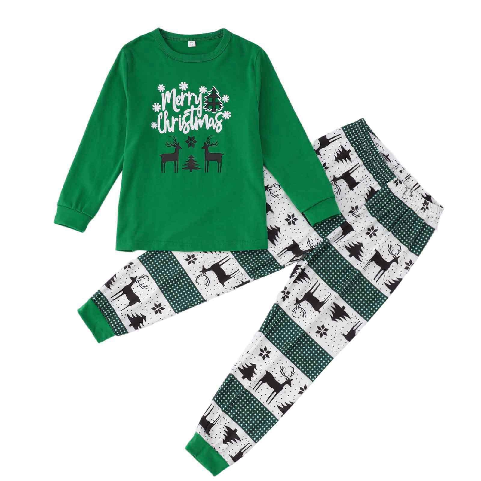 Kids matching Christmas pajamas in green with reindeer and holiday tree design