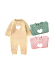 Set of knitted baby rompers with heart design in beige, dark green, and pink colors