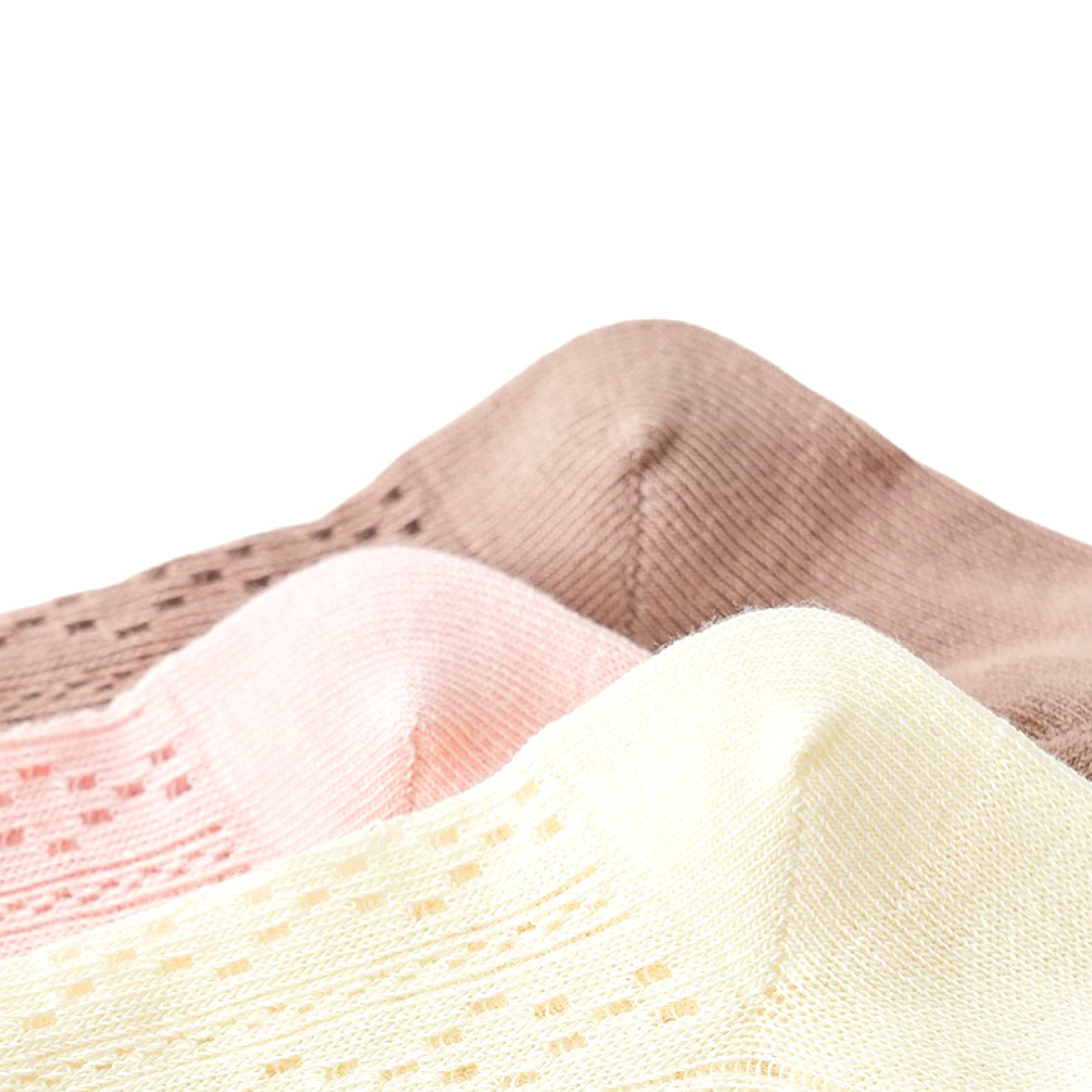 Close-up of lace knit baby socks in cotton material showing soft breathable texture in cream, pink, and brown.