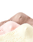 Close-up of lace knit baby socks in cotton material showing soft breathable texture in cream, pink, and brown.