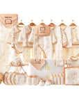 Love Baby-themed gift set including bodysuit, bibs, towel, pillow, wrap, socks, and gloves in soft pastel colors