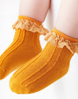 Mustard yellow lace frill baby socks, warm cotton knit with cute scalloped lace cuff.