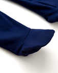 Close-up of navy blue cotton baby romper showing round neckline and zipper finish.