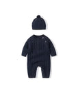 Navy blue cable knit baby romper with pom-pom hat, cozy winter outfit for babies.