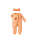Orange baby romper with ruffle front and matching bow headband, cozy cotton outfit
