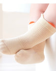 Baby wearing beige pastel cotton socks – gentle and cosy socks for toddlers