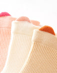 Close-up of pastel cuff detail on soft cotton baby socks