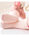 Baby wearing pink pastel cotton socks – lightweight and comfortable for daily wear