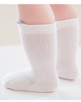 Baby wearing white pastel cotton socks – soft and breathable baby socks