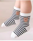 Baby wearing grey cotton socks with bear face design – toddler socks